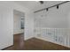 Upstairs hallway with white doors and wood floors at 8101 Spur Ct, Las Vegas, NV 89145