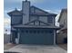 Two-story house with a teal garage door at 8101 Spur Ct, Las Vegas, NV 89145