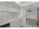 White kitchen with tile countertops and dishwasher at 8101 Spur Ct, Las Vegas, NV 89145