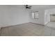 Spacious living room featuring tile floors and a ceiling fan at 8101 Spur Ct, Las Vegas, NV 89145