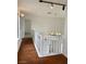 Upstairs hallway with hardwood floors and a chandelier at 8101 Spur Ct, Las Vegas, NV 89145