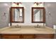 Double vanity bathroom with beige countertops and wood cabinets at 861 Zinnia Cir, Henderson, NV 89015