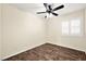 Bright bedroom with ceiling fan, wood-look floors, and window shutters at 861 Zinnia Cir, Henderson, NV 89015