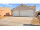 Two-car garage home with light tan exterior at 861 Zinnia Cir, Henderson, NV 89015