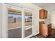 View of kitchen with backyard access through sliding glass doors at 861 Zinnia Cir, Henderson, NV 89015