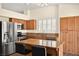 Kitchen with granite countertops, stainless steel appliances, and wood cabinets at 861 Zinnia Cir, Henderson, NV 89015