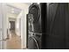 Laundry room with stacked washer and dryer and storage cabinet at 861 Zinnia Cir, Henderson, NV 89015