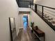 Modern entryway with wood-look floors, a staircase, and a full-length mirror at 8976 Sweet Chestnut Ln, Las Vegas, NV 89178