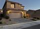 Two-story house with attached garage and a brick driveway, dusk at 8976 Sweet Chestnut Ln, Las Vegas, NV 89178