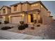 Two-story house with attached garage, landscaping, and a brick driveway at 8976 Sweet Chestnut Ln, Las Vegas, NV 89178