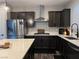 Modern kitchen with dark cabinetry, stainless steel appliances, and a quartz countertop at 8976 Sweet Chestnut Ln, Las Vegas, NV 89178