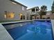 Inviting swimming pool in backyard with lounge chairs and surrounding homes visible at 8976 Sweet Chestnut Ln, Las Vegas, NV 89178