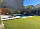 Stunning pool with artificial turf and modern landscaping at 8976 Sweet Chestnut Ln, Las Vegas, NV 89178