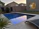 Modern rectangular pool with built-in spa and blue lighting at 8976 Sweet Chestnut Ln, Las Vegas, NV 89178