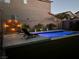 Relaxing backyard pool with lounge chairs and decorative wall at 8976 Sweet Chestnut Ln, Las Vegas, NV 89178