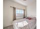 Cozy bedroom with striped bedding and window at 9303 Gilcrease Ave # 2177, Las Vegas, NV 89149