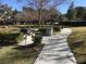 Picnic tables, grills, and a paved walkway in a park setting at 9612 World Cup Dr, Las Vegas, NV 89117