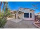 Covered patio and gravel backyard with mature desert landscaping at 9612 World Cup Dr, Las Vegas, NV 89117