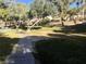 Pathway winds through a well-maintained grassy area with trees at 9612 World Cup Dr, Las Vegas, NV 89117