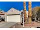 House exterior with a white garage door and brick landscaping at 9612 World Cup Dr, Las Vegas, NV 89117