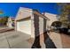 House exterior showcasing a white garage door and walkway at 9612 World Cup Dr, Las Vegas, NV 89117