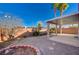 Covered patio with gravel yard and mature trees at 9612 World Cup Dr, Las Vegas, NV 89117