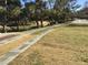 Wide paved pathway meanders through a grassy landscape at 9612 World Cup Dr, Las Vegas, NV 89117