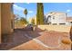 Backyard features a gravel area, a grill, and a partially paved pathway at 9700 Port Orange Ln, Las Vegas, NV 89134