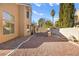 Large backyard with gravel, a grill, and a winding paved pathway at 9700 Port Orange Ln, Las Vegas, NV 89134