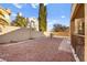 Gravel backyard with a built-in grill and fencing at 9700 Port Orange Ln, Las Vegas, NV 89134