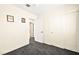 Bedroom with grey carpet and access to another room at 9700 Port Orange Ln, Las Vegas, NV 89134