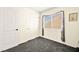 Well-lit bedroom featuring a window with blinds and grey carpet at 9700 Port Orange Ln, Las Vegas, NV 89134