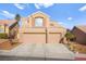 Two-story house with two-car garage and desert landscaping at 9700 Port Orange Ln, Las Vegas, NV 89134