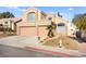 Two-story house with a two-car garage and desert landscaping at 9700 Port Orange Ln, Las Vegas, NV 89134