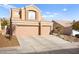 Two-story house with a two-car garage and nicely landscaped front yard at 9700 Port Orange Ln, Las Vegas, NV 89134