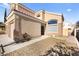 Two-story house with a two-car garage and walkway to the front door at 9700 Port Orange Ln, Las Vegas, NV 89134