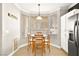 Breakfast nook with wood chairs and a round table, near large windows at 9700 Port Orange Ln, Las Vegas, NV 89134