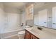 Bathroom with bathtub, shower, and wood vanity at 9802 Twin Mill St, Las Vegas, NV 89178