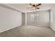 Well-lit bedroom with carpet flooring and ceiling fan at 9802 Twin Mill St, Las Vegas, NV 89178