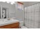 Clean bathroom with single vanity, shower/tub combo, and window at 10350 Blue Ginger Dr, Las Vegas, NV 89135