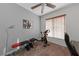 Bright home gym with exercise bike, weight bench, and floor lamp at 10350 Blue Ginger Dr, Las Vegas, NV 89135