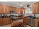Modern kitchen with light wood cabinets, granite countertops, and stainless steel appliances at 10350 Blue Ginger Dr, Las Vegas, NV 89135