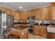 Modern kitchen with light wood cabinets, granite countertops, and stainless steel appliances at 10350 Blue Ginger Dr, Las Vegas, NV 89135