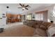 Spacious living room featuring a large sectional sofa and a ceiling fan at 10350 Blue Ginger Dr, Las Vegas, NV 89135