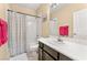 Bathroom with shower/tub combo, vanity, and striped curtain at 10825 Bernini Dr, Las Vegas, NV 89141