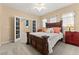 Bedroom with double doors leading to hallway and an oriental cabinet at 10825 Bernini Dr, Las Vegas, NV 89141