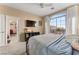 Bright bedroom with large window, TV, and access to another room at 10825 Bernini Dr, Las Vegas, NV 89141