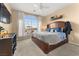 Bedroom with large window, a ceiling fan, and a walkout balcony at 10825 Bernini Dr, Las Vegas, NV 89141