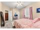 Bedroom with pink bedding, full-length mirror, and closet at 10825 Bernini Dr, Las Vegas, NV 89141