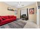 Bedroom with red couch, workspace, and colorful rug at 10825 Bernini Dr, Las Vegas, NV 89141